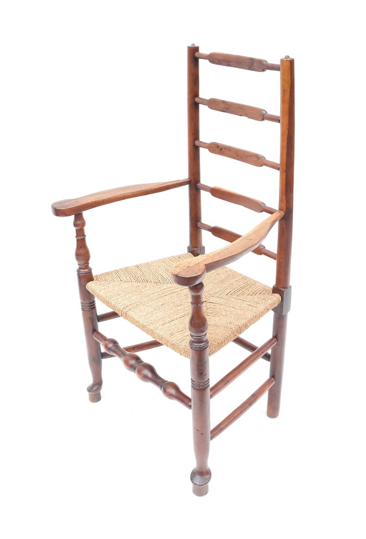 Antique American Ladder Back Armchair: Antique American ladder back armchair with rush seat and turned stiles and cross stretchers. [26 1/2" W x 17" D x 43 1/2" H; 18" H to seat]. Previously restored.