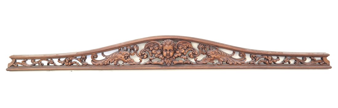 Baroque Style Pierced Shaped Transom: Early 20th century, the composite wood crest modeled with cherubim centered by dolphins and scrolls, [H 8" x L 77" x D 2 1/4"], overall good condition with minor wear.
