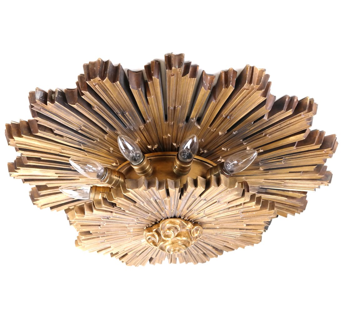 J.E. Caldwell Starburst Light Fixture: American bronze starburst-form dimensional light fixture, Caldwell trademark logo. [28 1/2" Dia x 8 1/2" D].