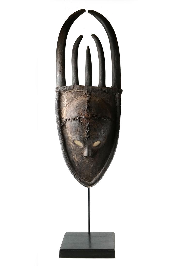 West African Mask on Stand: West African mask on stand, possibly trade. [35 1/4" H x 13 1/2" L; Base: 2" H x 11" W x 9 1/2" D].