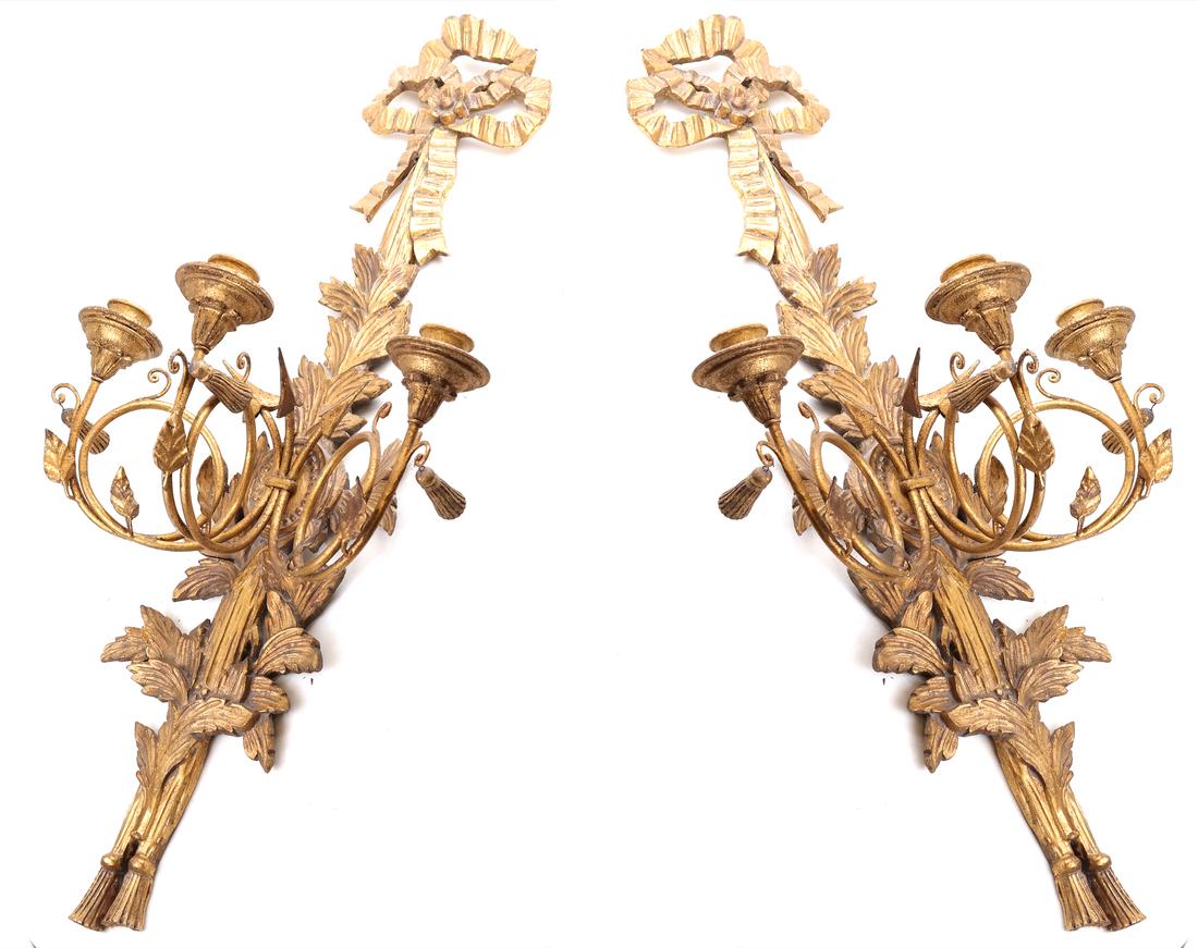 Pair of Gilt Decorated Sconces: Pair of mid-20th century three-light sconces with ribbon, wheat and tassel motif. [16" LL x 12" D x 36" H].