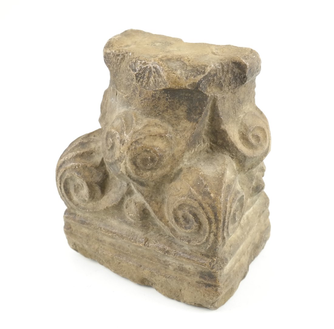 Ancient-Style Stone Pilaster Capital: Modeled with volutes, the reverse suspended from an inset ring. [6 3/4" H x 5 1/2" W x 4" D]. Overall wear and few losses commensurate with age.