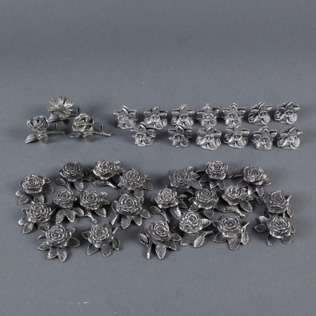 37 Silver Card & Napkin Holders: Comprises: 13 silver floral card holders, 3 sterling floral card holders, and 21 silver napkin holders, [Total weight approx: 23 ozt.].