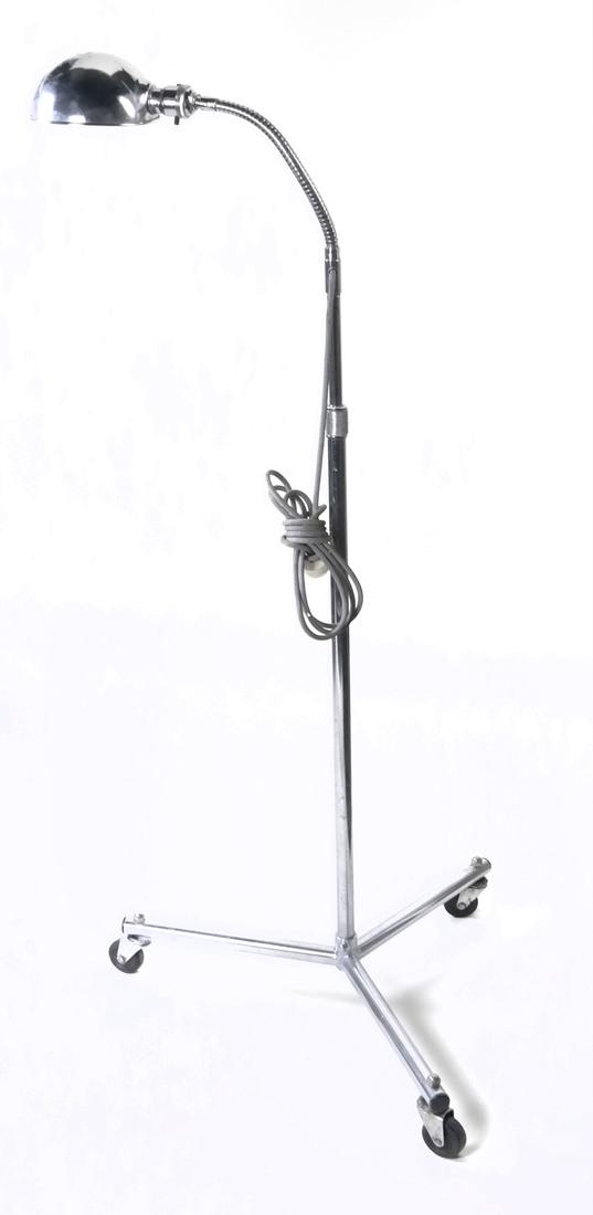 Chrome Lamp on Stand: Height-adjustable goose-neck lamp on three wheel stand. Dimensions: 21.00 " ⌀ x 51.00 " H; 