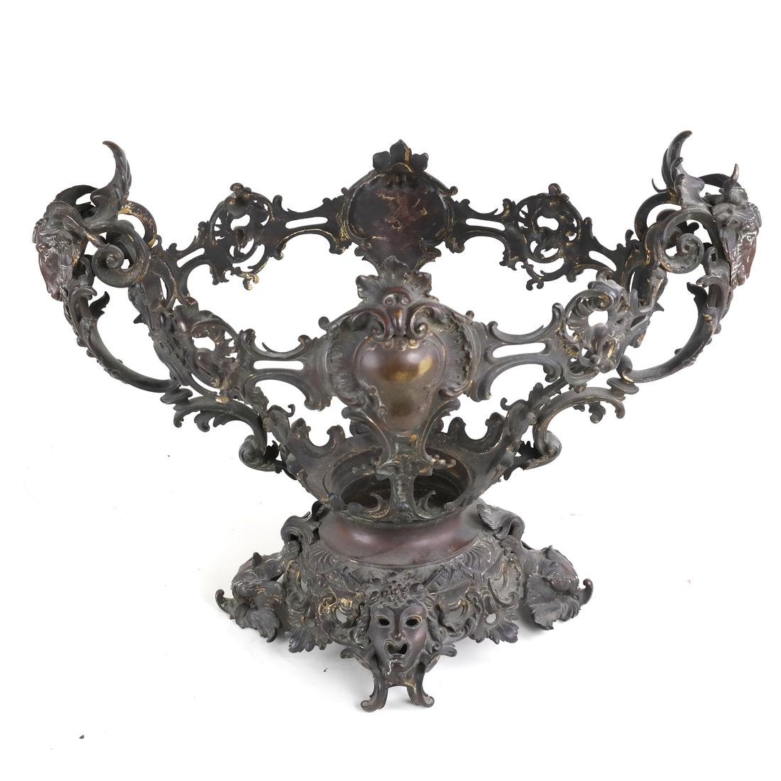 Ornate Bronze Centerpiece: Having goat heads, reticulated foliage, masks, dolphins. Missing crystal inset, frame only. [21" W x 16" H x 13" D].