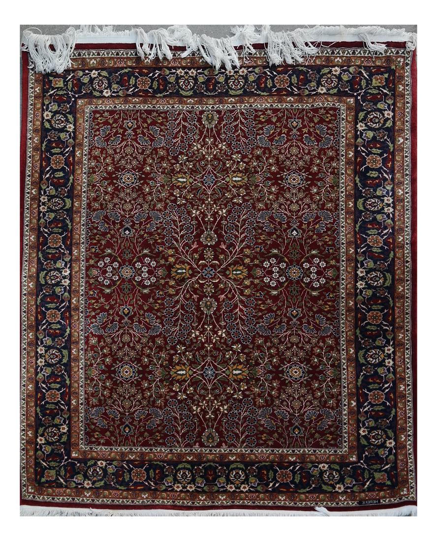 Signed Turkish Rug: Turkish rug, having a floral motif, with a maroon ground central field. Signed "Hereke" in outer most border. [83" L x 59" W]. Overall good condition.