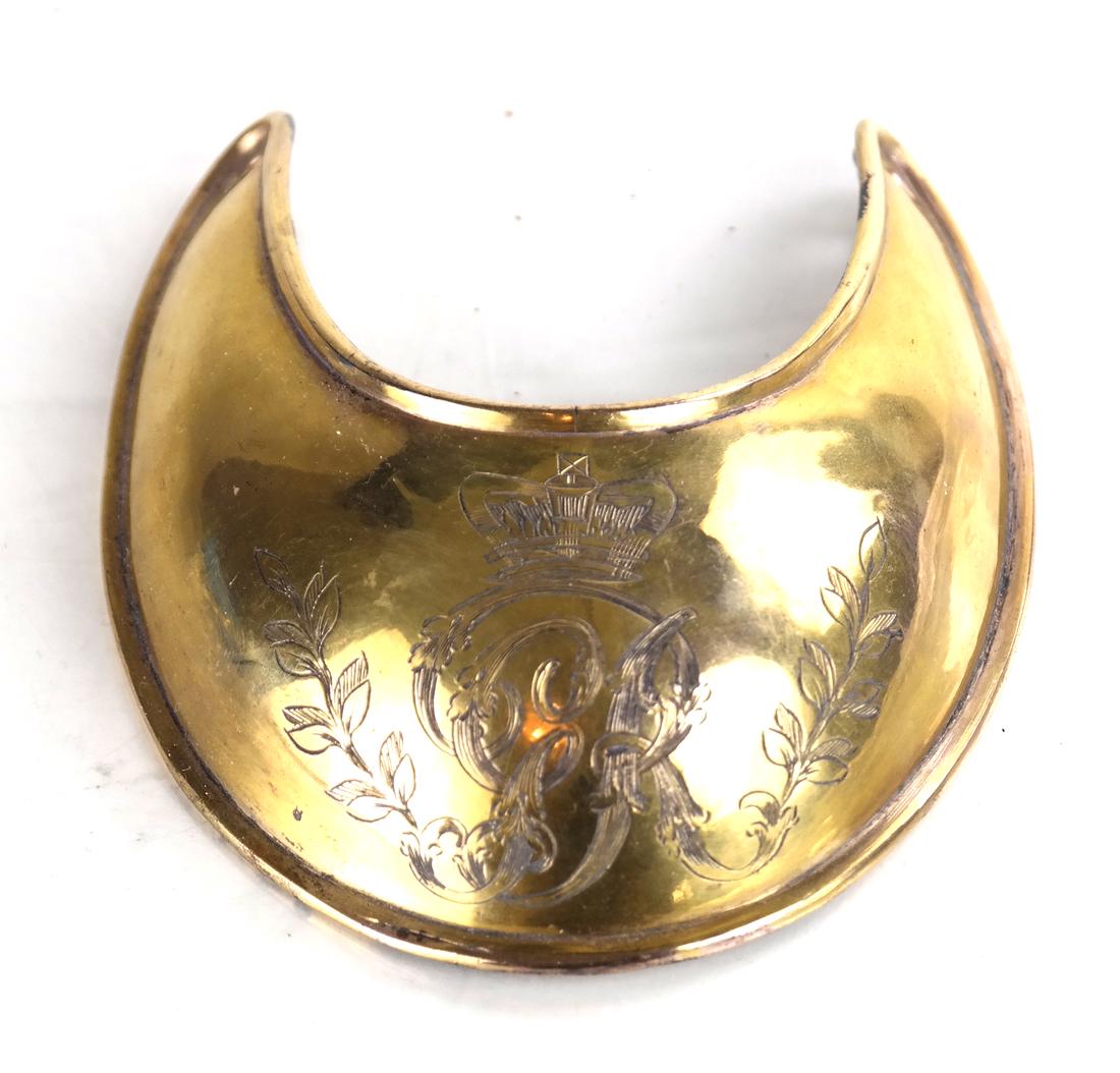 Incised Chin Guard: Gold-plated bronze chin guard.[4 1/2" H x 3 1/4" W x 1 1/4" D].