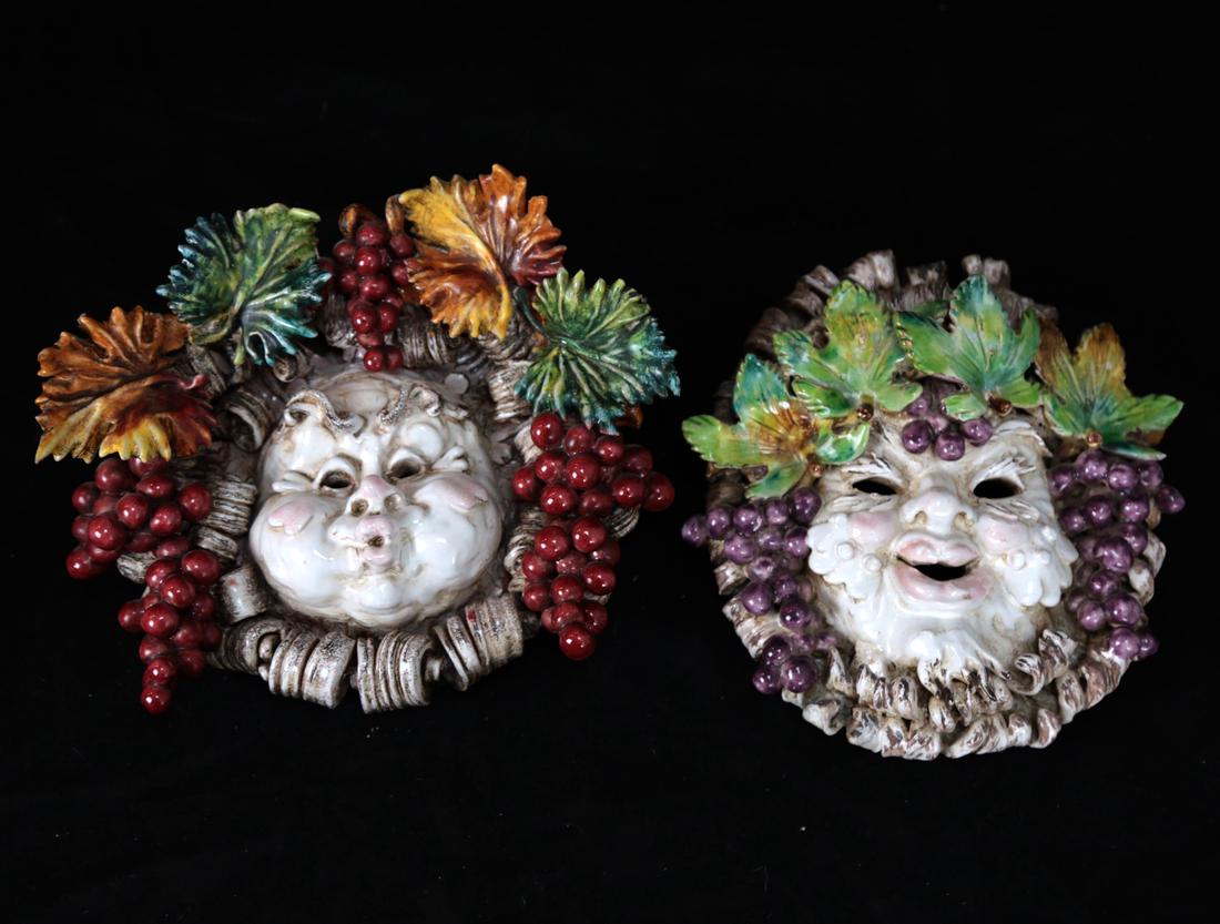 Pair of Majolica Reliefs: Pair of majolica reliefs, each finely detailed with fruits, berries, and allegorical faces. [7" H x 9 1/2" W x 3 1/2" D].