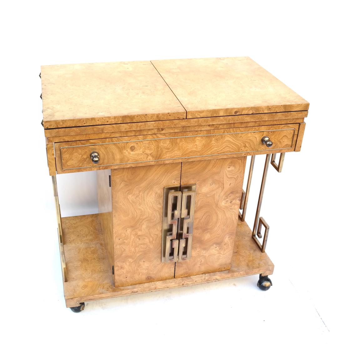 Art Deco-Style Table/Bar Cart: Art Deco-style two-door, one-drawer bar cart with a double hinged top. Having a geometric/Greek key design on the sides and supported on casters. By Mastercraft. [29 1/2" H x 30" L x 18" D].