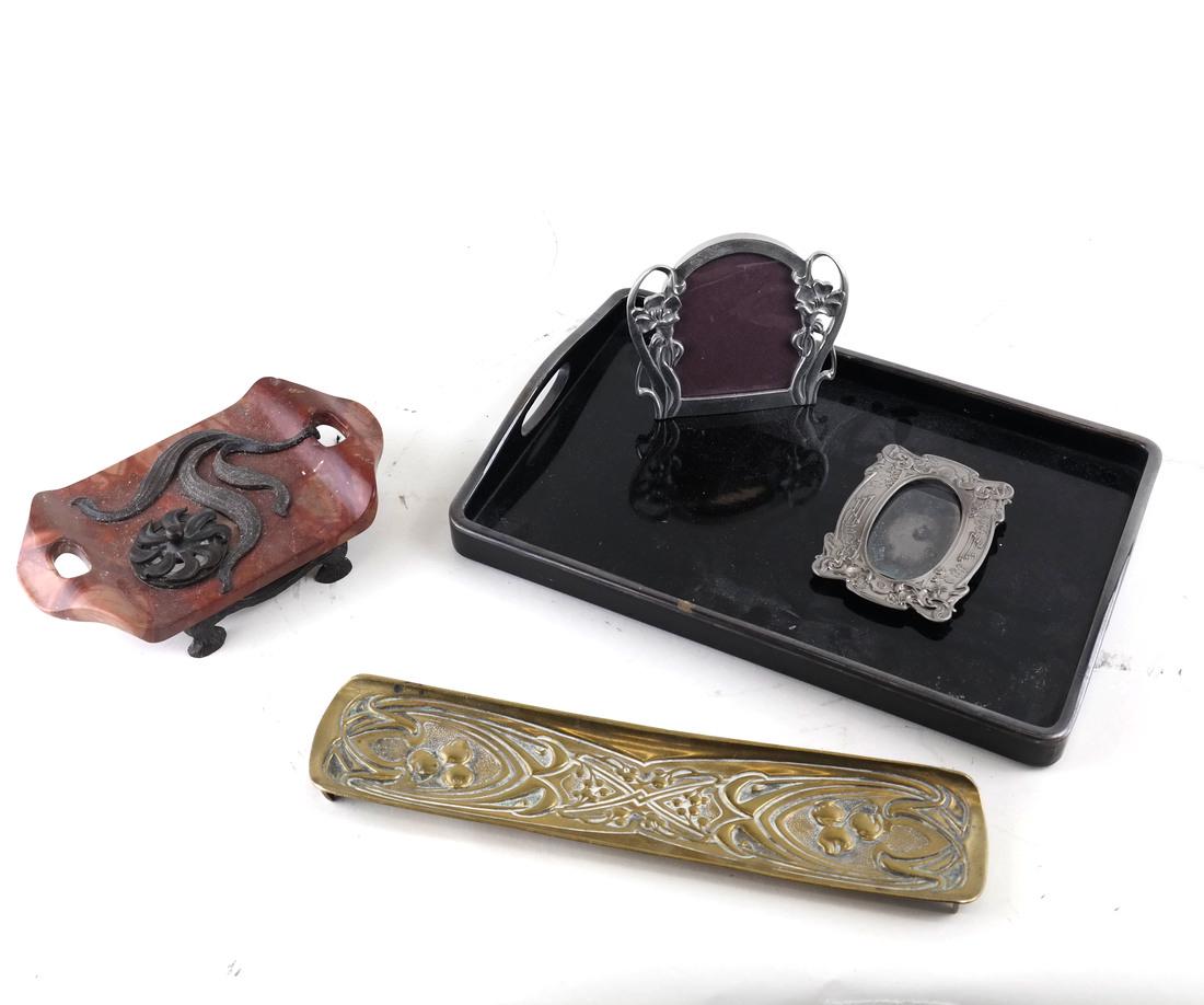 Five Desk Articles: Comprises primarily Art Nouveau style: a standish, two various small picture frames; a pen tray and a black lacquered small rectangular tray with silver-plated rims. [1 1/2" H to 3 1/2" H; 2 1/2" L to