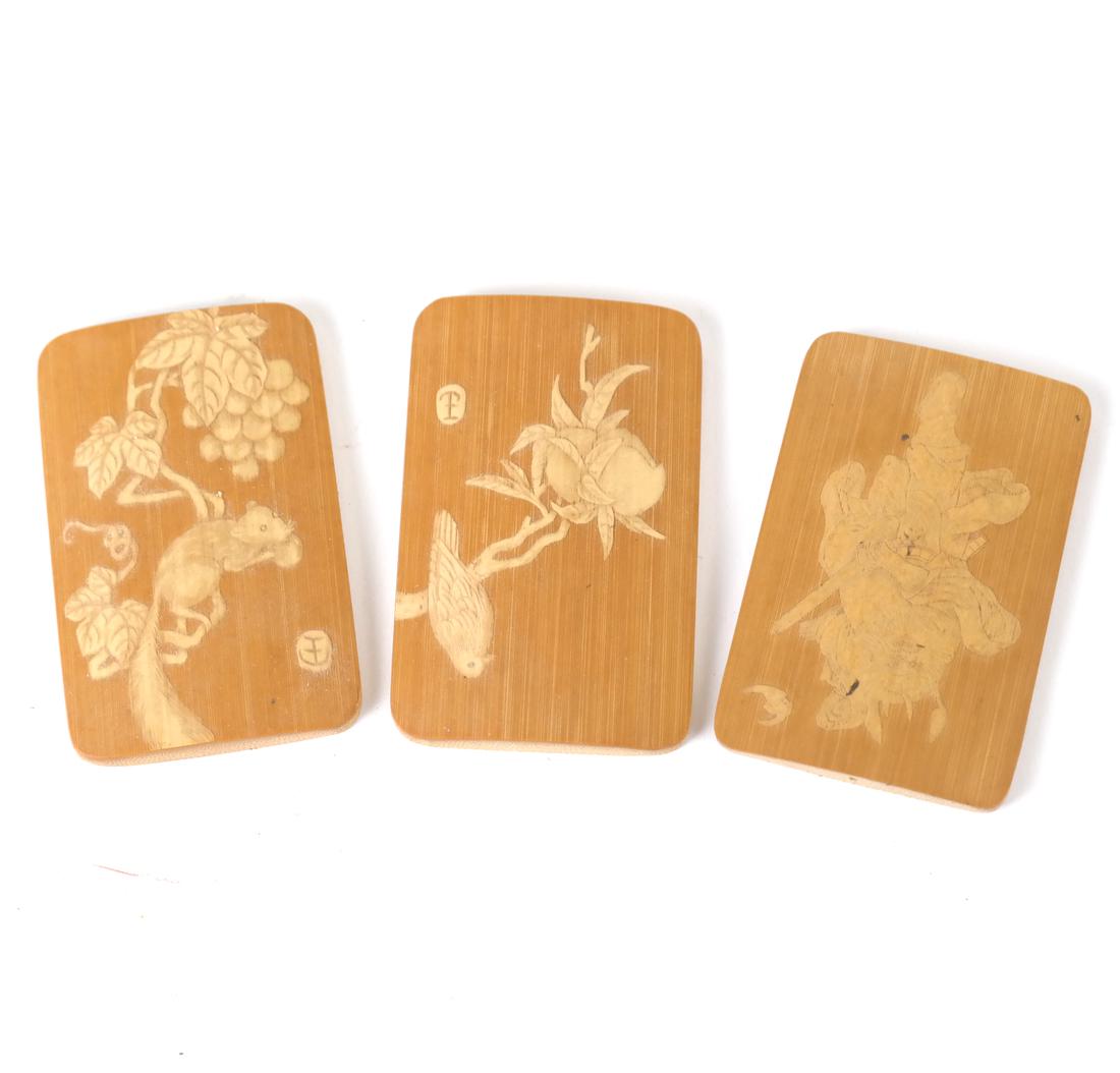 Three Chinese Carved Bamboo Tiles: Comprising a pair carved by a single artist, with character mark and a similar example. [2 1/2" H x 1 1/2" W].