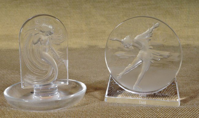 2 Lalique Crystal Pcs. Lalique Soc. Of Amer. 1992: 2 Lalique Crystal Pcs. Lalique Soc. Of Amer. 1992 Paperweight, Skater & Nude Plaque Ring Holder. 4 1/4" H & 4" H.