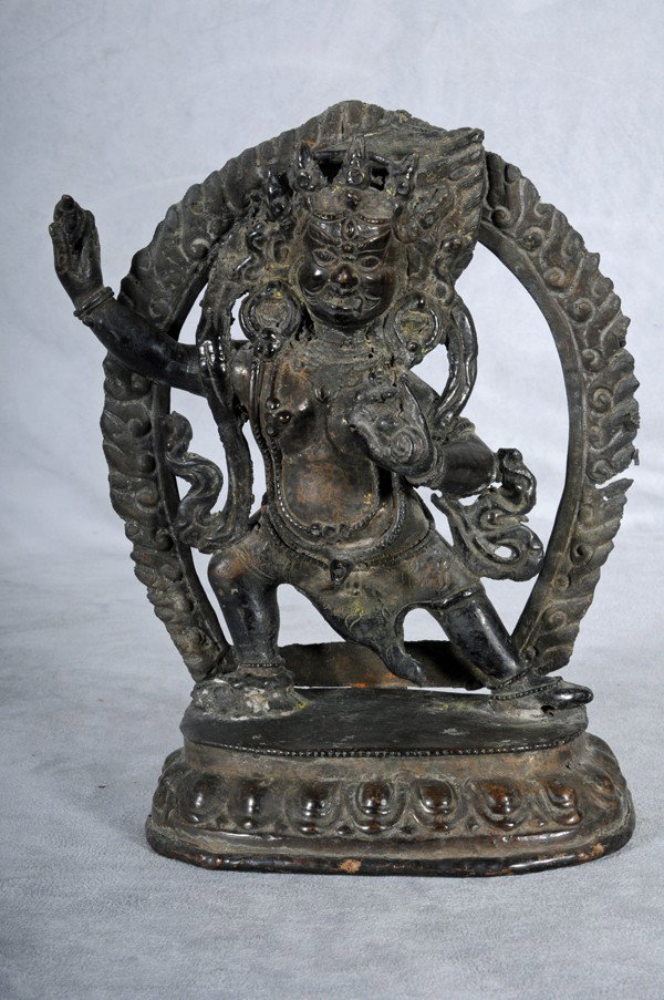 19TH C. NEPALESE BRONZE FIGURE OF A GOD. DANCING F: 19TH C. NEPALESE BRONZE FIGURE OF A GOD. DANCING FIGURE W/ A FLAME BACK. 9" H X 6 3/4" W.