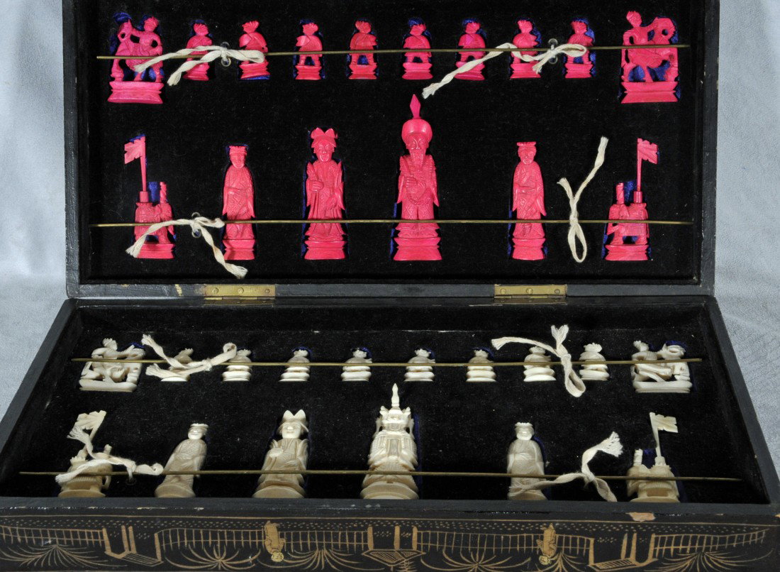 CHINESE IVORY CHESS SET. BLACK & GILT LACQUER CASE: CHINESE IVORY CHESS SET. BLACK & GILT LACQUER CASE. RED & WHITE CHESS PCS, AND THE CASE OPENS TO BE THE BOARD. TALLEST PC APP. 4" H & SMALLEST APP. 1 1/2" H.