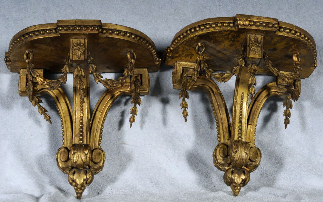 PR. ANTIQUE HALF ROUND GILT WALL BRACKETS WITH FLO: PR. ANTIQUE HALF ROUND GILT WALL BRACKETS WITH FLORAL SWAG DECORTION. SOME CRACKS. 7 1/8" H X 7 1/2" W X 4 3/4" D.