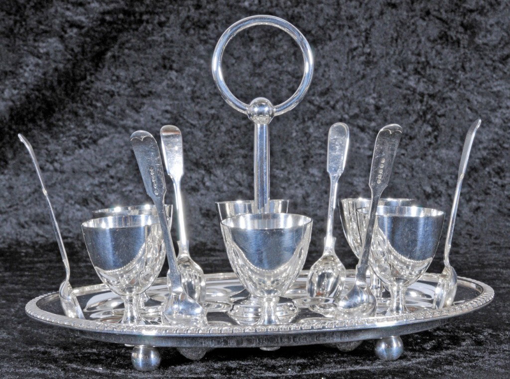 ANTIQUE ENGLISH "OLD PLATE" SHEFFIELD EGG SERVER. 6 : ANTIQUE ENGLISH "OLD PLATE" SHEFFIELD EGG SERVER. 6 CUPS AND 6 SPOONS RESTING ON AN OVAL TRAY W/ HANDLE. SLOTS FOR THE SPOONS. MAKER JAY CO. OXFORD. 7 1/2" H X 10 1/4" W X 8" D.