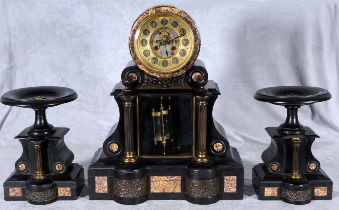 3 PC. BLACK SLATE & MARBLE CLOCK SET. SLATE CLOCK : 3 PC. BLACK SLATE & MARBLE CLOCK SET. SLATE CLOCK W/ A ROUND BRASS FACE ON THE TOP. DOUBLE COLUMN BASE W/ MARBLE PANELS. PR. MATCHING TAZZAS. 19" H X 15 1/2" W CLOCK - 10 1/2" H X 7 1/2" W TAZZA