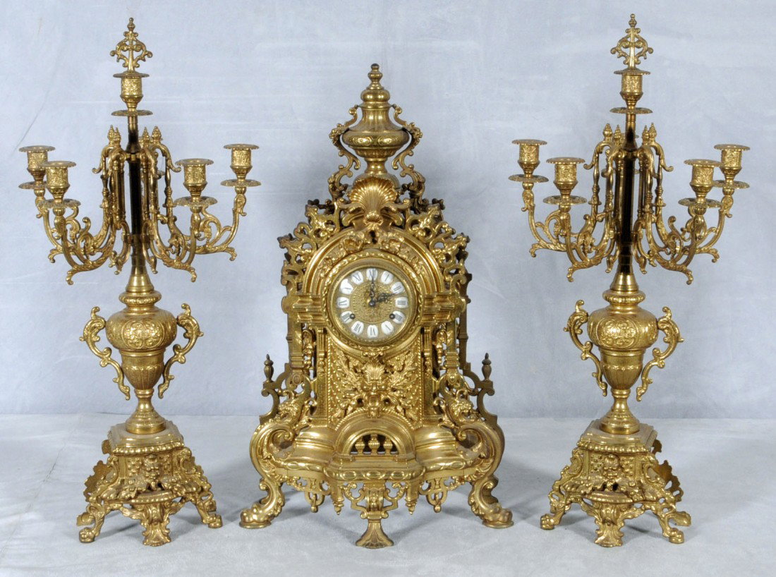 3 PC. BRONZE CLOCK SET IN THE LOUIS XV STYLE. CON: 3 PC. BRONZE CLOCK SET IN THE LOUIS XV STYLE. CONSISTING OF A CLOCK & A PAIR OF MATCHING 6 LIGHT CANDELABRA. CLOCK 24" H X 14 1/2" W. - CAND. 26 1/2" H X 12 1/2" W