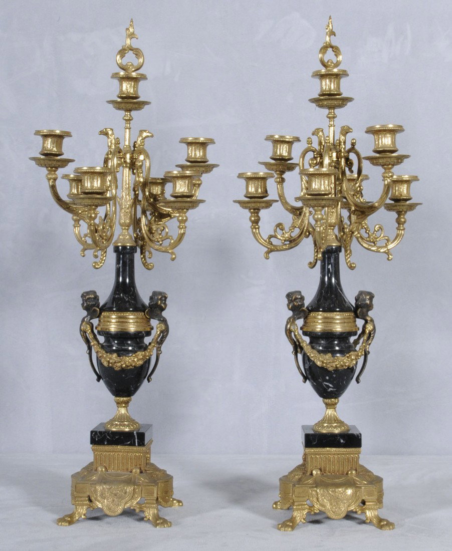 PR. OF ITALIAN ORMOLU 7 LIGHT CANDELABRA. SCROLLE: PR. OF ITALIAN ORMOLU 7 LIGHT CANDELABRA. SCROLLED ARMS SUPPORTED BY A BLACK MARBLE URN. 27 1/2" H X 10" SQ.