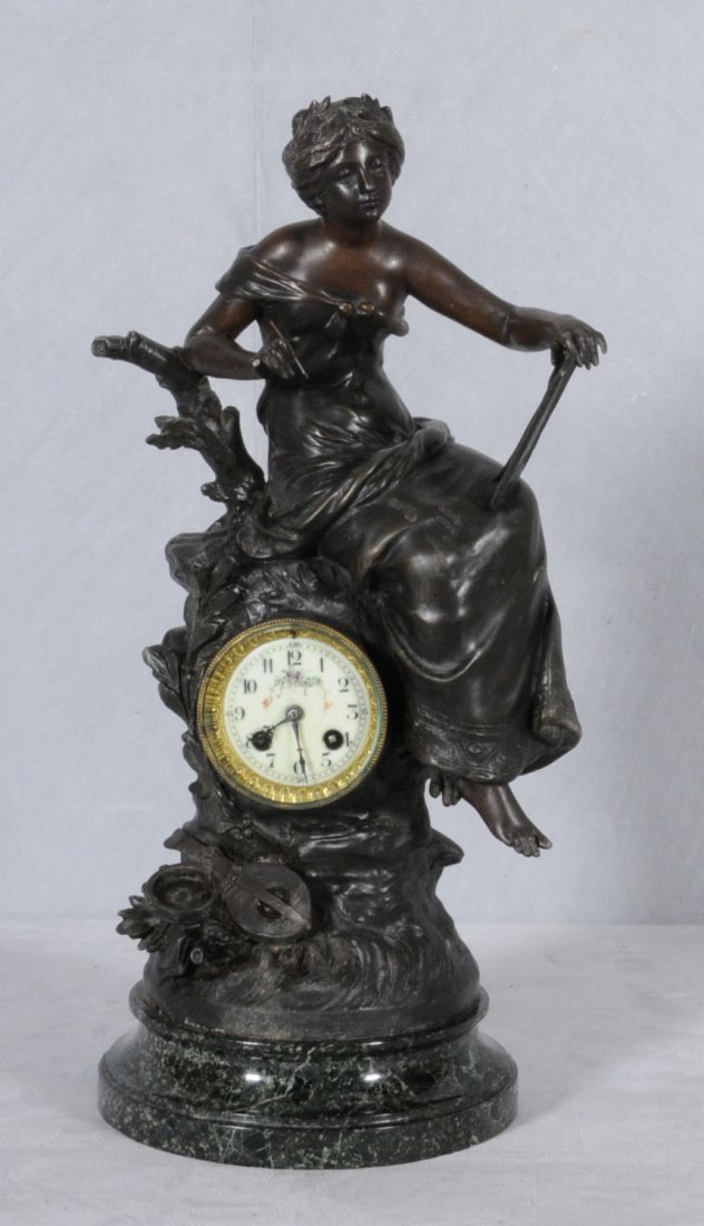 ANTIQUE FRENCH SPELTER FIGURAL CLOCK. CLOCK INSET I: ANTIQUE FRENCH SPELTER FIGURAL CLOCK. CLOCK INSET IN A TREE STUMP, FIGURE OF A LADY SITTING NEXT TO THE CLOCK. SIGNED L & F MOREAU. 21" H X 10" W X 9" D