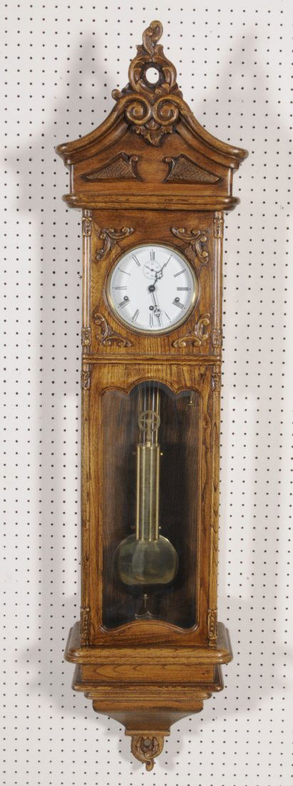 OAK CASE REGULATOR WALL CLOCK. BEVELLED GLASS FRONT: OAK CASE REGULATOR WALL CLOCK. BEVELLED GLASS FRONT DOOR. ONE WEIGHT. 60" H X 14 1/4" W X 8 1/4" D