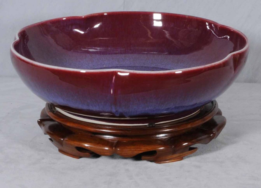 LARGE SANG DE BOEUF SCALLOPED BOWL. TEAKWOOD STAND: LARGE SANG DE BOEUF SCALLOPED BOWL. TEAKWOOD STAND. 5 1/2" H X 20" DIA.