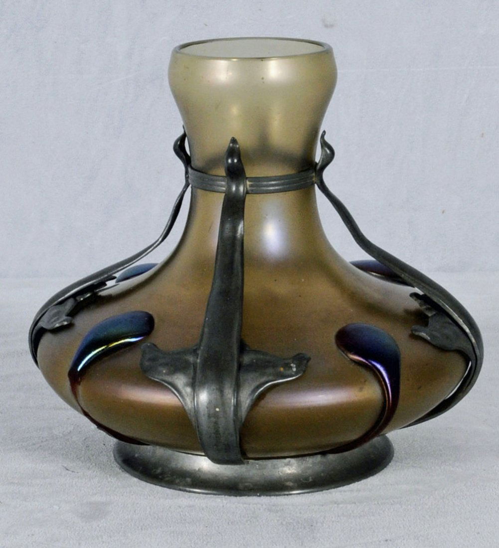 LOETZ ART GLASS LIGHT BROWN VASE. IRIDESCENT GLASS: LOETZ ART GLASS LIGHT BROWN VASE. IRIDESCENT GLASS. METAL HOLDER. 8" H X 8 1/2" DIA. (TK)