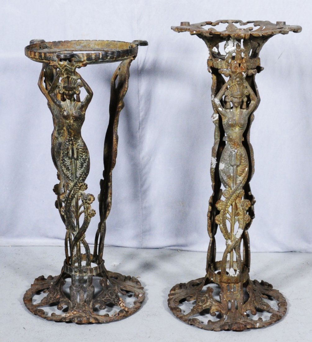 2 AMERICAN WROUGHT IRON STANDS W/ FIGURES OF WOMEN: 2 AMERICAN WROUGHT IRON STANDS W/ FIGURES OF WOMEN DECORATING THE STANDS. ONE SIGNED "BOOTH CO.CHICAGO." 33 1/4" H X 14 1/4" DIA. & 30 5/8" H X 14 1/8" DIA. (TK)