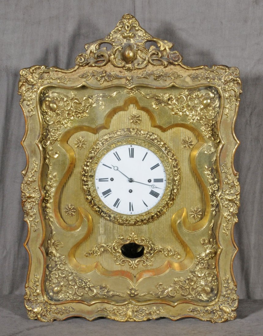 ANTIQUE GILT WOOD CARVED WALL CLOCK. FLORAL DECORAT: ANTIQUE GILT WOOD CARVED WALL CLOCK. FLORAL DECORATION. SHADOW BOX FRAME. ENAMEL DIAL. 27" X 18 3/4". (TK)