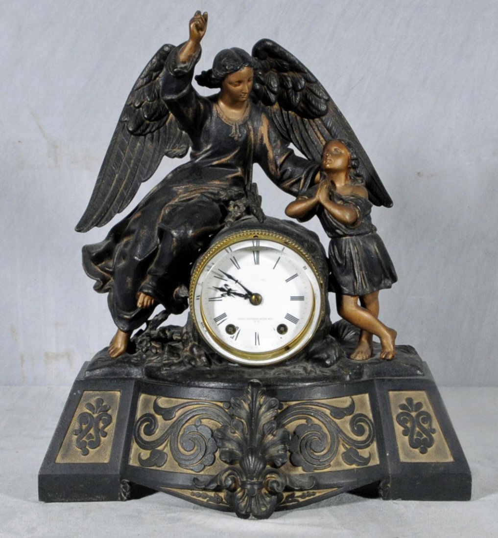 ANTIQUE AMERICAN SPELTER MANTEL CLOCK. A FIGURE OF: ANTIQUE AMERICAN SPELTER MANTEL CLOCK. A FIGURE OF AN ANGEL W/ A CHILD PRAYING DECORATES THE TOP OF THE SETH THOMAS SONS, INC. NEW YORK, CLOCK. 16" H X 14 1/4" W X 7 1/2" D. (TK)