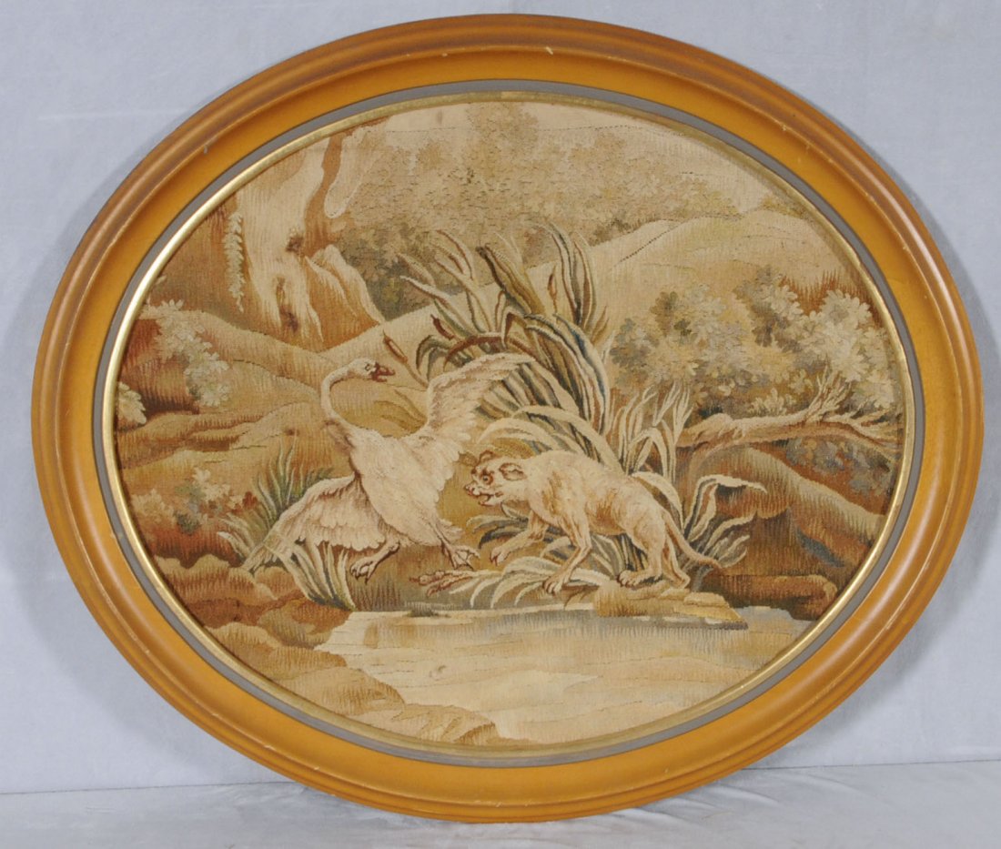 OVAL FRAMED AUBUSSON STYLE TAPESTRY DEPICTING A FIG: OVAL FRAMED AUBUSSON STYLE TAPESTRY DEPICTING A FIGURE OF A SWAN & A DOG BY A LAKE. 20" X 24". (TK)