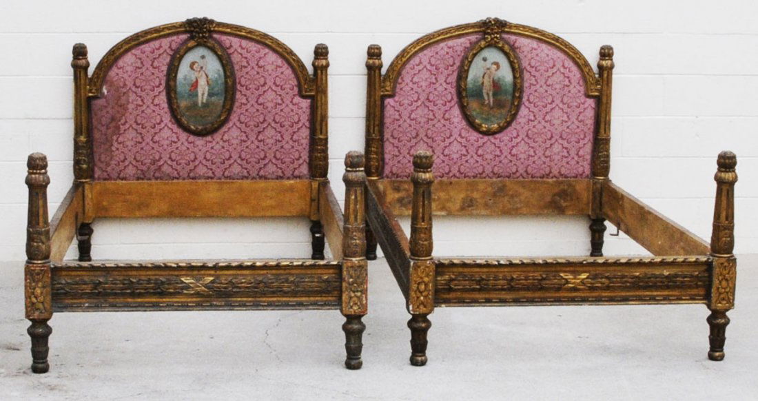 PR. ANTIQUE FRENCH LXVI STYLE TWIN BEDS. CARVED GI: PR. ANTIQUE FRENCH LXVI STYLE TWIN BEDS. CARVED GILT FLORAL DECORATED FRAMES. REEDED COLUMNS AND PAINTED OVAL PANELS. RED UPHOLSTERY. BEDS COMPLETE. 46" H X 83" W X 47" D. INSIDE 77" W X 43 1/4" D. (T