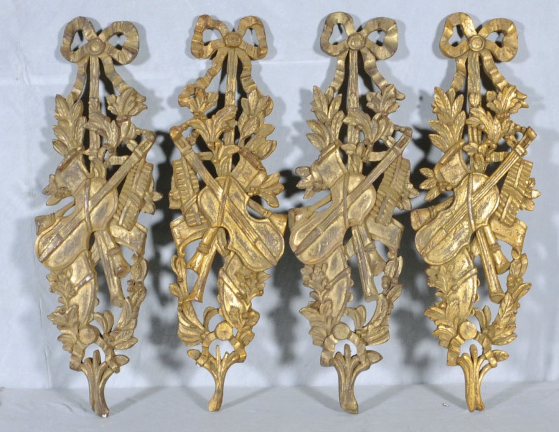 4 GILTWOOD CARVED WALL DECORATIONS. RIBBON, FLORAL: 4 GILTWOOD CARVED WALL DECORATIONS. RIBBON, FLORAL & MUSICAL DECORATION. 36 1/2" H X 12" W. (TK)