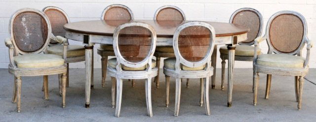 9 PC FRENCH LOUIS XVI STYLE DINING ROOM SET. CONS: 9 PC FRENCH LOUIS XVI STYLE DINING ROOM SET. CONSISTING OF A TABLE & 8 SIDE CHAIRS. CANE BACKS AND SEATS WITH LOOSE CUSHIONS. PAINTED WHITE FINISH. GOOD. 39" H X 76 1/2" W X 51" D.