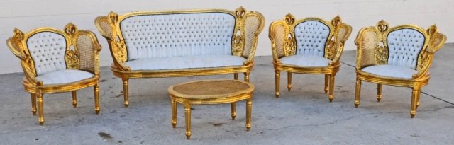 5 PC CARVED GILTWOOD LOUIS XVI STYLE SALON SET. CON: 5 PC CARVED GILTWOOD LOUIS XVI STYLE SALON SET. CONSISTING OF A SETTEE WITH CANE SIDES, 3 CLOSED ARM CHAIRS, ALL W/ TUFFED BACKS, & A ROUND TABLE. GOOD.