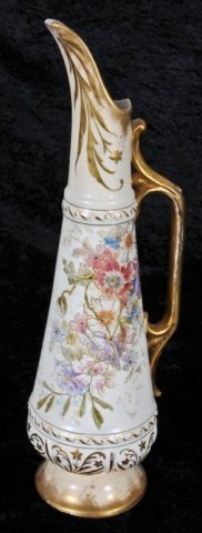 GERMAN ROYAL BONN CERAMIC PITCHER. MULTI-COLOR FLO: GERMAN ROYAL BONN CERAMIC PITCHER. MULTI-COLOR FLORAL DECORATION. CHIPS/BASE. 15" H X 5" W. (AS)