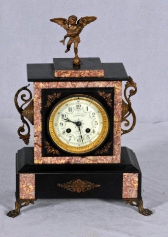 FRENCH BLACK SLATE AND MARBLE CLOCK WITH A CUPID O: FRENCH BLACK SLATE AND MARBLE CLOCK WITH A CUPID ON THE TOP. ORMOLU MOUNTS. GOOD. CLOCK NOT WORKING. 15" H X 11" W X 5" D.