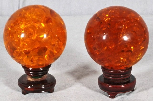 2 ORIENTAL AMBER BALLS ON STANDS. 1 IS DARKER T: 2 ORIENTAL AMBER BALLS ON STANDS. 1 IS DARKER THAN THE OTHER. GOOD. 5 1/2" DIA.