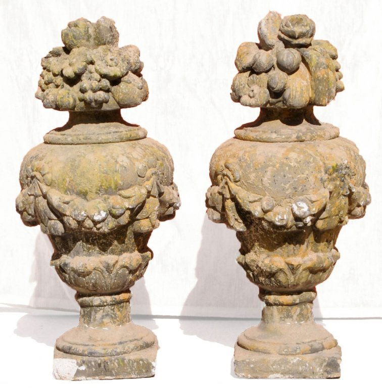 PAIR FRENCH ANTIQUE CAST LIMESTONE URNS. WITH FRUIT DEC: PAIR FRENCH ANTIQUE CAST LIMESTONE URNS. WITH FRUIT DECORATED TOPS. CHIP ON THE BASE. 32" H X 16" DIA.
