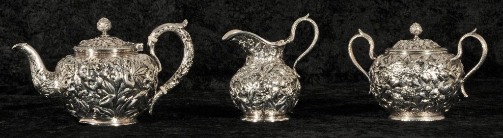 3 PC. STERLING SILVER S. KIRK & SONS TEA SET. REPOU: 3 PC. STERLING SILVER S. KIRK & SONS TEA SET. REPOUSSE PATTERN. CONSISTING OF A TEA POT, CREAMER AND A SUGAR BOWL. 28.5 TROY OZ. GOOD. TP = 5 3/4" H X 8" W X 4" D.