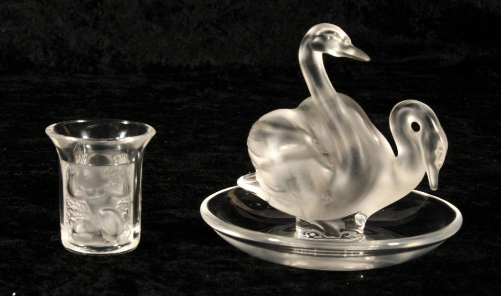 2 PIECES OF FRENCH LALIQUE. A JIGGER AND A SWAN RING HO: 2 PIECES OF FRENCH LALIQUE. A JIGGER AND A SWAN RING HOLDER. GOOD. RING= 3 1/2" H X 4" DIA.