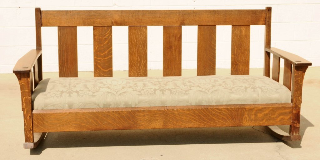 OAK ARTS AND CRAFTS ROCKING SETTEE. STRAIGHT SLATT D: OAK ARTS AND CRAFTS ROCKING SETTEE. STRAIGHT SLATT DESIGN. GREEN UPHOLSTERED SEAT. STAMPED L & J G STICKLEY ON THE BACK. GOOD. 32" H X 72" W X 30" D.