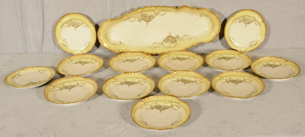 14 PC. FRENCH LIMOGES PORCELAIN FISH SET. YELLOW AND GI: 14 PC. FRENCH LIMOGES PORCELAIN FISH SET. YELLOW AND GILT DECORATION. PLATES 8 1/2" DIA. GOOD. PLATTER 24" L.
