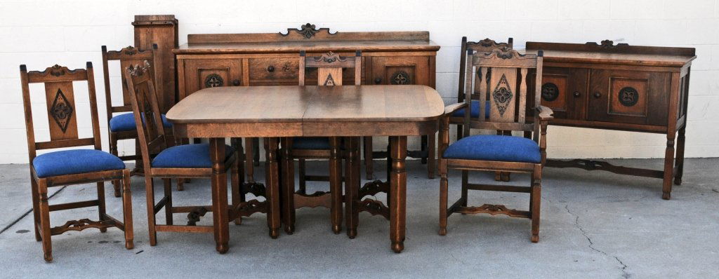 9 PC. CARVED OAK DINING ROOM SET. CONSISTING OF A TABLE: 9 PC. CARVED OAK DINING ROOM SET. CONSISTING OF A TABLE WITH 3 LEAVES, 6 CHAIRS AND 2 SIDEBOARDS. CIRCA 1925. BUFFET 43 1/2" H X 73 3/4" W X 23" D. GOOD. T = 30 3/4" H X 57 1/4" W X 46" D.