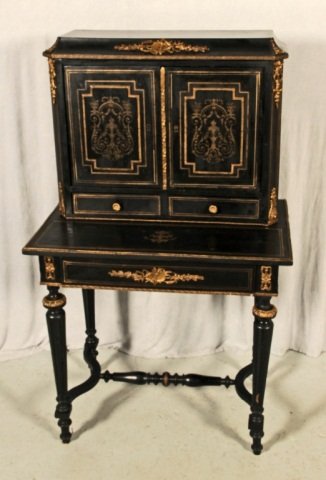 ANTIQUE BLACK FRENCH LOUIS PHILLIPE WRITING DESK .: ANTIQUE BLACK FRENCH LOUIS PHILLIPE WRITING DESK . DOUBLE DOORS AND TWO DRAWERS BELOW. BRASS FLORAL INLAID DESIGN. REEDED TAPERED LEGS. SOME CRACKS. 51 3/4" H X 30 1/2" W X 19" D.