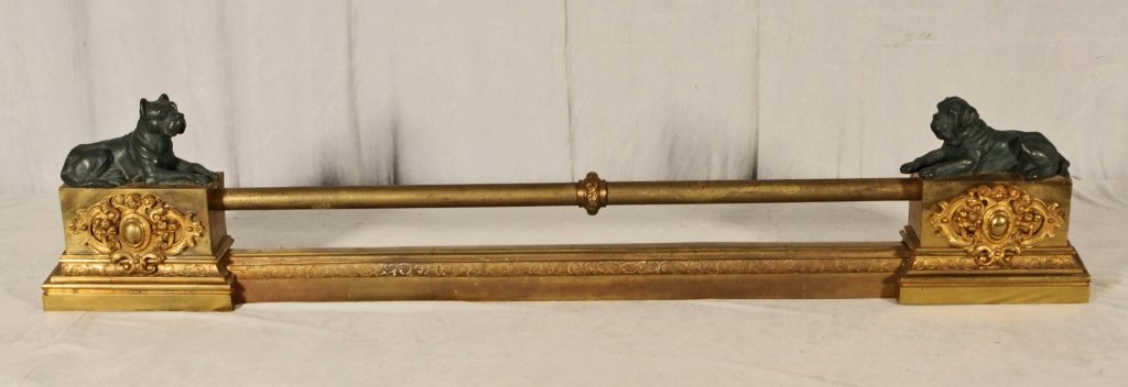 3 PC. ENGLISH BRONZE CHENET SET. BULL DOG ANDIRONS: 3 PC. ENGLISH BRONZE CHENET SET. BULL DOG ANDIRONS ON EACH END AND SCROLL DECORATION. DOUBLE RODS IN THE CENTER. GOOD. 9 1/2" H X 51" W X 4" D.