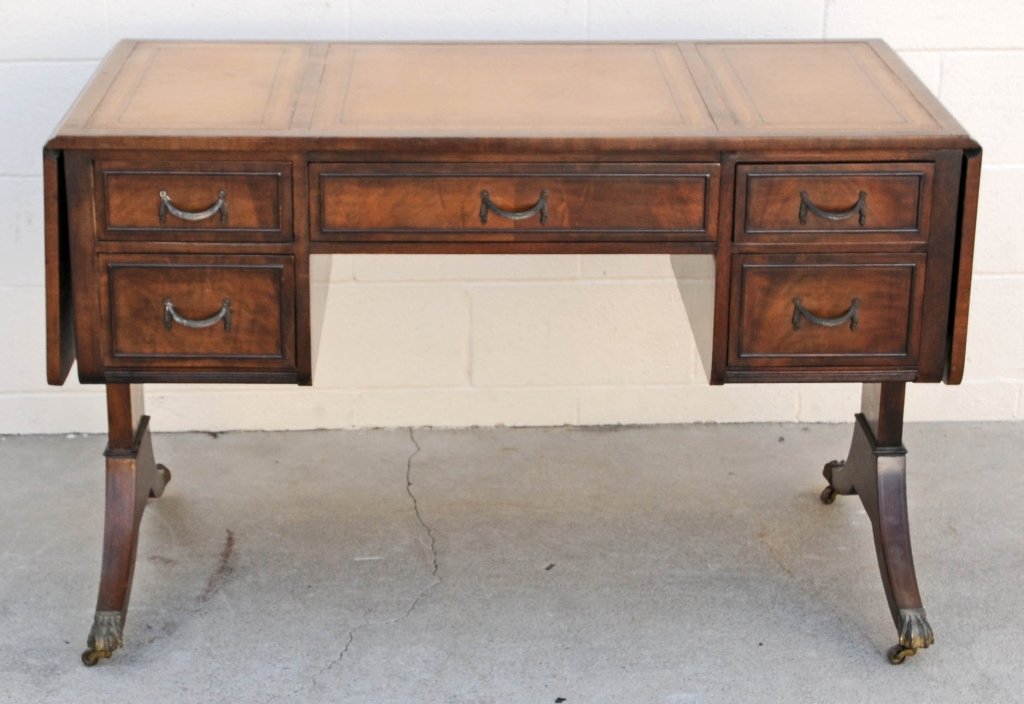 WALNUT ENGLISH STYLE DESK. THREE SECTIONED HAND: WALNUT ENGLISH STYLE DESK. THREE SECTIONED HAND TOOLED LEATHER TOP. DROP LEAF SIDES WITH 5 DRAWERS AND DUNCAN PHYFE STYLE LEGS. OPEN 73 3/4". GOOD. 30 1/2" H X 48" W X 24" D.