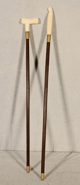 2 CHINESE CARVED IVORY HANDLED CANES. ONE IS CORN: 2 CHINESE CARVED IVORY HANDLED CANES. ONE IS AN EAR OF CORN AND THE OTHER IS TREE BARK DESIGNED. GOOD. 40" H 37" H.
