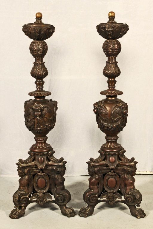 PR LATE 19th C. FRENCH BRONZE ANDIRONS. DECORATED WITH: PR LATE 19th C. FRENCH BRONZE ANDIRONS. DECORATED WITH WINGED CUPID HEADS AND A LEAF DECORATED SECTION. RESTING ON A TRIANGULAR BASE WITH WINGED FIGURES AND PAW FEET. GOOD. 43" H X 14" SQ.