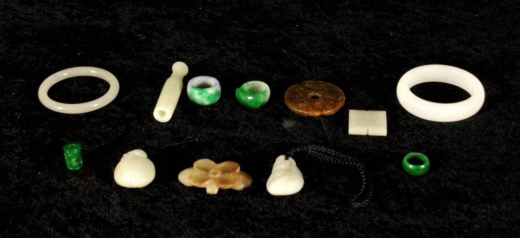 12 PC. CHINESE CARVED JADE PCS. CONSISTING OF 2: 12 PC. CHINESE CARVED JADE PCS. CONSISTING OF 2 BRACELETS, 3 RINGS, A CIGARETTE HOLDER, 3 FLORAL PCS & 3 MISCELLANEOUS PCS. GOOD. LG 3" DIA & SM 3/4" DIA.